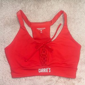Carries Sports Bra in size XS, red, pre-owned.  brand is Year of Ours. Tie front